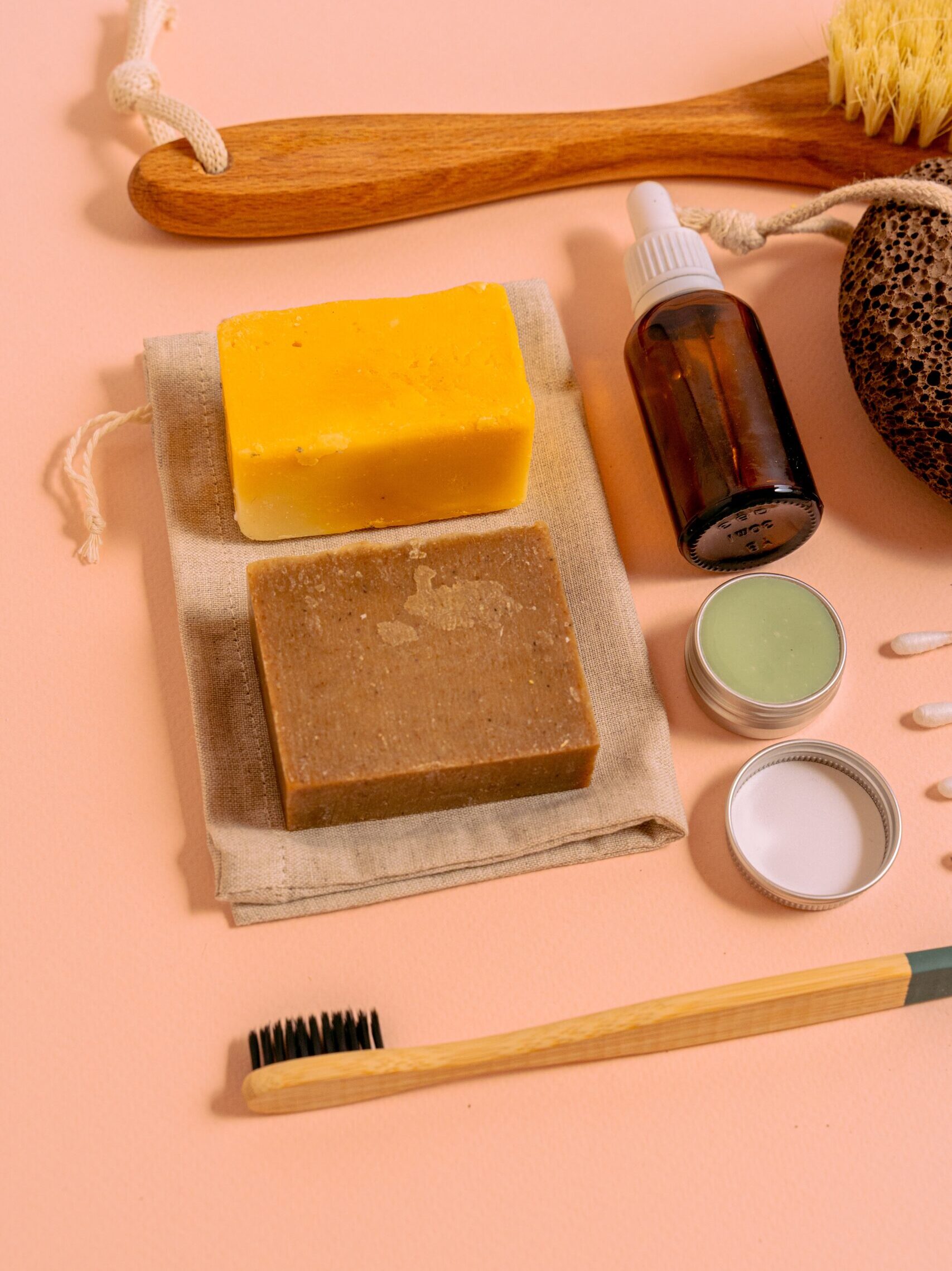 2 bathing bars on a cloth surrounded by various personal care items